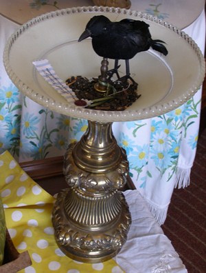 Bird feeder made from a lamp base and glass ceiling shade