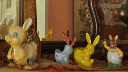 Vintage Easter bunny decorations on the mantle.