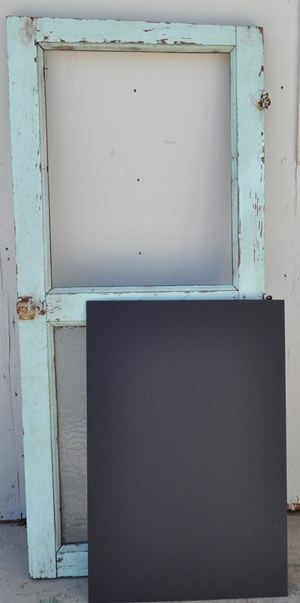 Black foam board to make a chalkboard with this antique, half glass door.