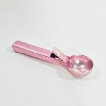 Vintage ice cream scoop. Retro, pink aluminum with spring, lever handle.