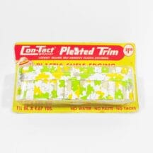 Vintage shelf edging. Pleated plastic in yellow and green on white background. Still in original packaging.