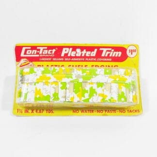 Vintage shelf edging. Pleated plastic in yellow and green on white background. Still in original packaging.