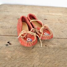 Child's vintage moccasins. Red with blue and white beading. Perfect for Native American or Western decor.
