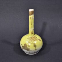 Small, vintage sake bottle. Yellow with gold, painted chrysanthemums and trim. 4-3/4" tall.