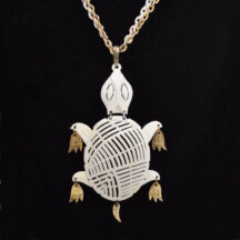 Vintage turtle necklace made by Alan in the 1970's. White and gold tone metal.