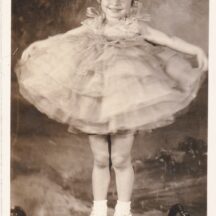 Real photo postcard of little girl in a pageant or dance costume