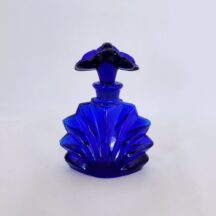 Cobalt blue perfume bottle with ground stopper. Stopper is two flowers. Vintage 1980s.