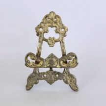 Small brass easel. 4-3/4" tall. Lots of patina. Made in Hong Kong in the 1960s